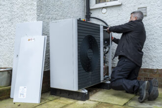 An air source heat pump repairman from Valiant replaces a Wilo pump inside an air source heat pump unit at a house in Folkestone, United Kingdom on Dec. 23, 2021. Credit: Andrew Aitchison/In pictures via Getty Images